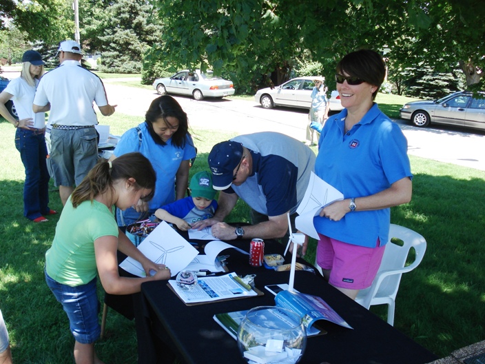 A family coloring wind turbines at Northeast Engineers’s booth.